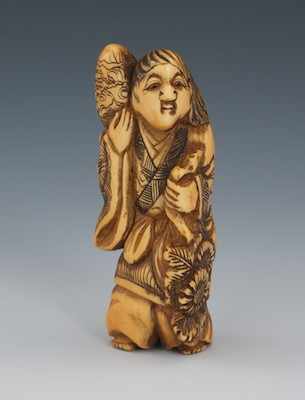 Appraisal: A Carved Ivory Netsuke of a Figure with Sun Flowers