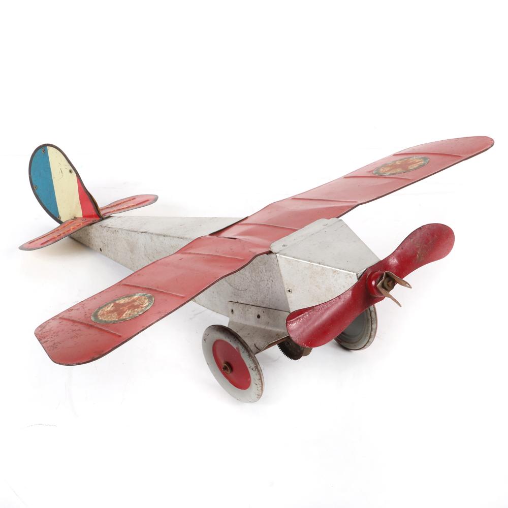 Appraisal: EMPIRE EXPRESS MONOPLANE PRESSED STEEL AND TIN LITHO AIRPLANE TOY