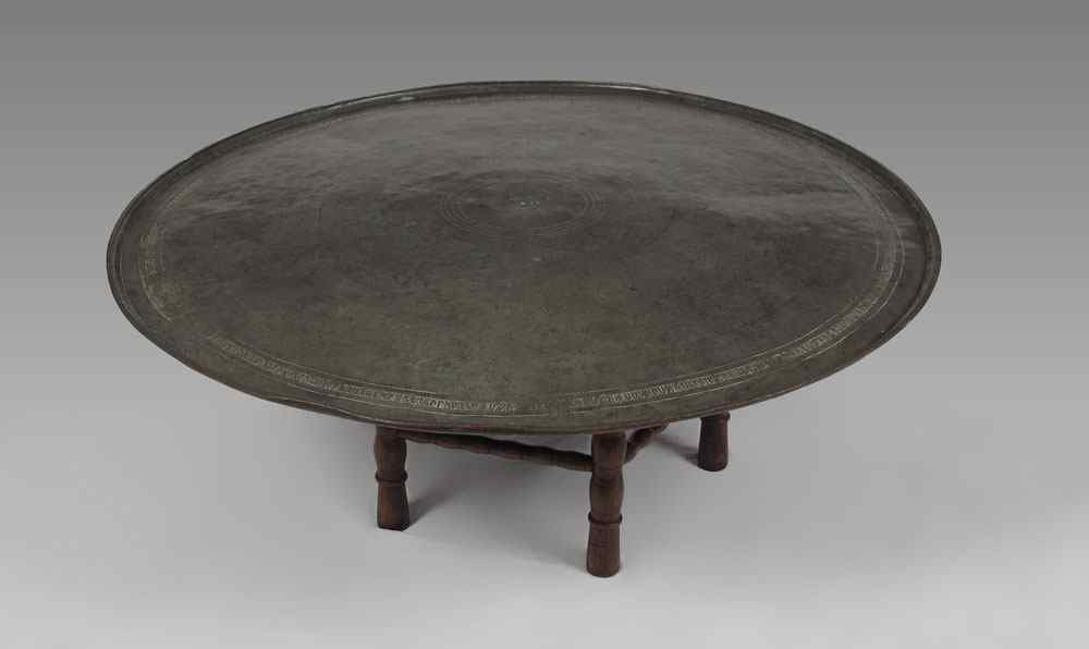 Appraisal: PERSIAN TRAY ON STAND COFFEE TABLE Low circular coffee table