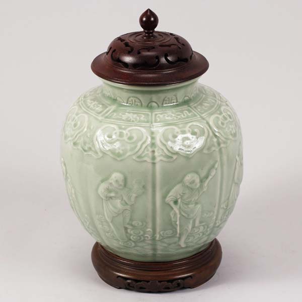 Appraisal: Chinese celadon porcelain jar with carved wooden lid decorated with