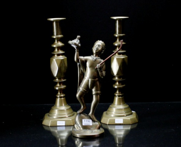 Appraisal: a pair of brass candlesticks together with a brass figure