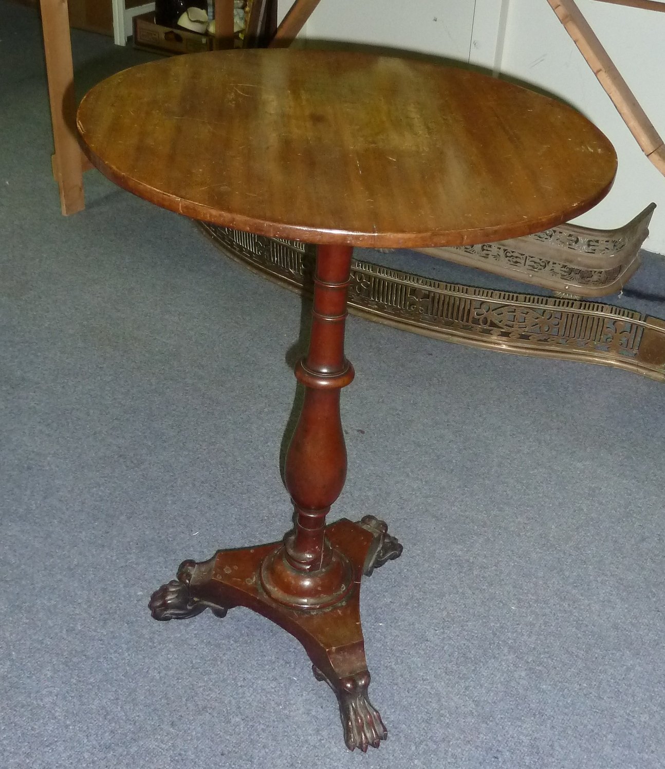 Appraisal: A circular mahogany table on a turned column and tripod