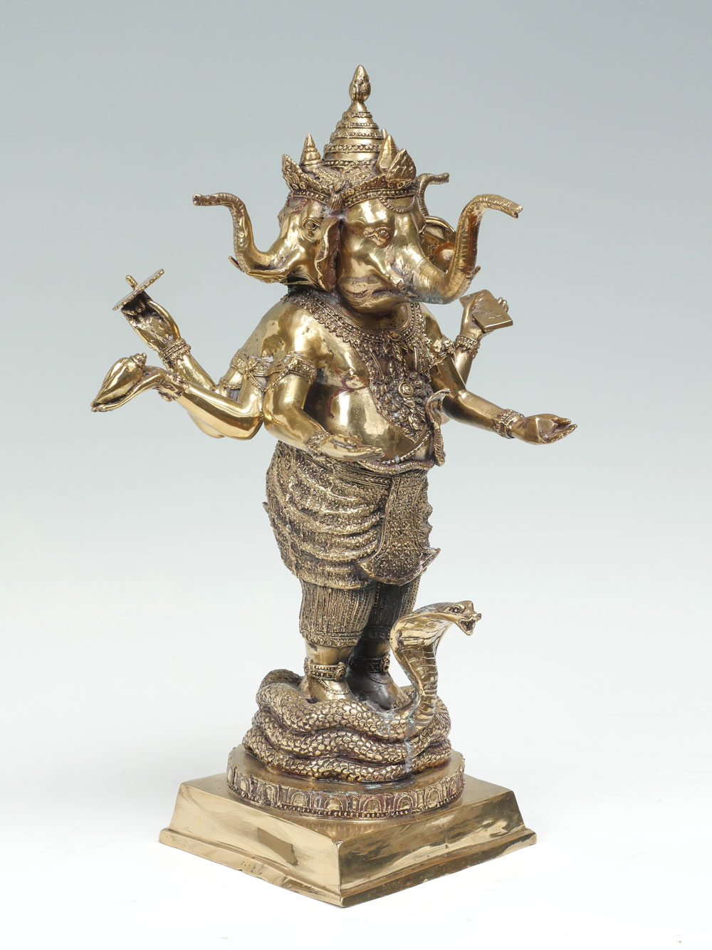 Appraisal: POLISHED BRONZE - HEADED GANESH Polished cast bronze Ganesh having