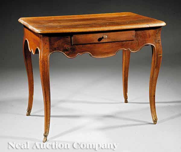 Appraisal: A Louis XV Walnut Table c molded top scalloped apron