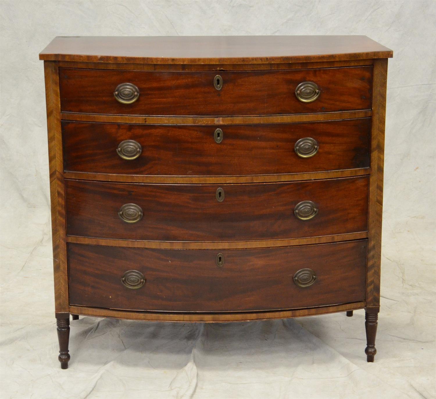 Appraisal: Mahogany Sheraton bow front chest original brasses paneled ends turned