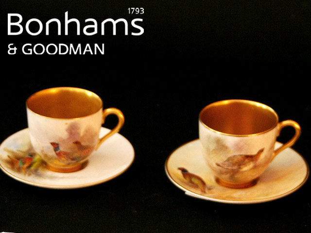 Appraisal: A pair of Royal Worcester cabinet cups and saucers painted