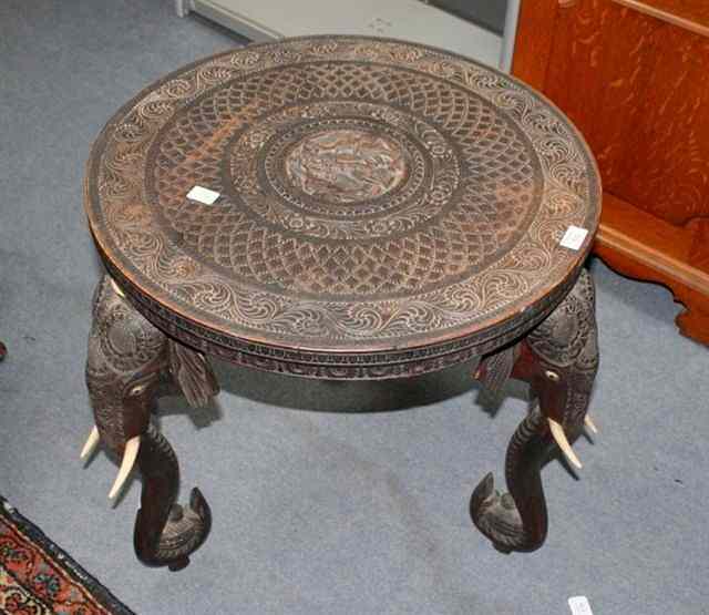 Appraisal: AN INDIAN CIRCULAR HARDWOOD TABLE the top carved in relief