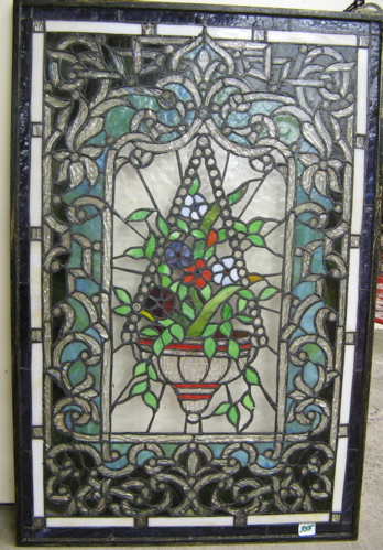 Appraisal: A STAINED AND LEADED GLASS WINDOW PANEL having a central