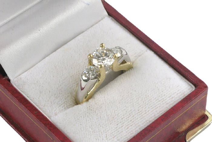 Appraisal: DIAMOND AND EIGHTEEN KARAT GOLD RING centering a round brilliant-cut