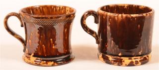 Appraisal: Two Rockingham Glazed Yellowware Mugs Two Rockingham Glazed Yellowware Mugs