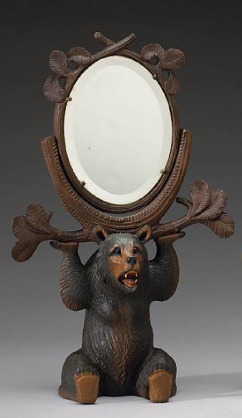 Appraisal: A Black Forest lindenwood dressing mirror late th early th