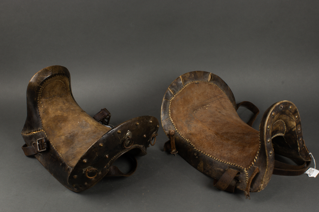 Appraisal: LOT OF TWO MIDDLE EASTERN SADDLES DECORATED WITH GILT METAL