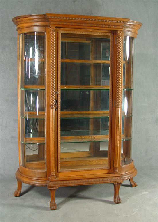 Appraisal: Golden Oak Curved Glass China Cabinet Circa Carved and shaped