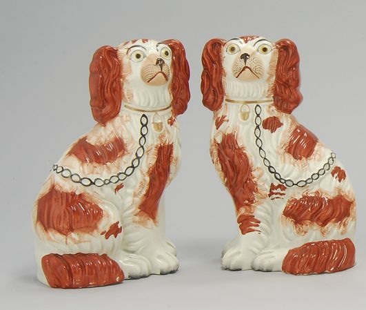 Appraisal: PAIR OF STAFFORDSHIRE SPANIELS Circa In rust-red and white with