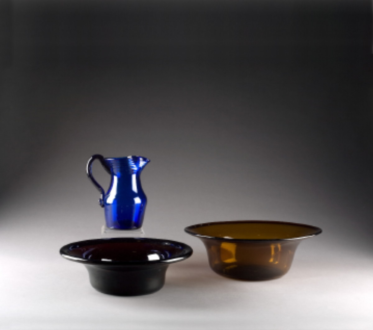 Appraisal: AMERICAN FREE-BLOWN DARK YELLOW GLASS PAN CIRCA - The pan