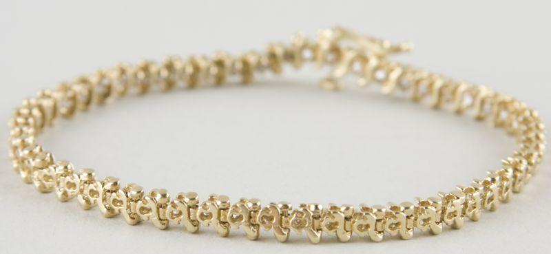 Appraisal: KT Yellow Gold Diamond Tennis Bracelet with S-bar form with