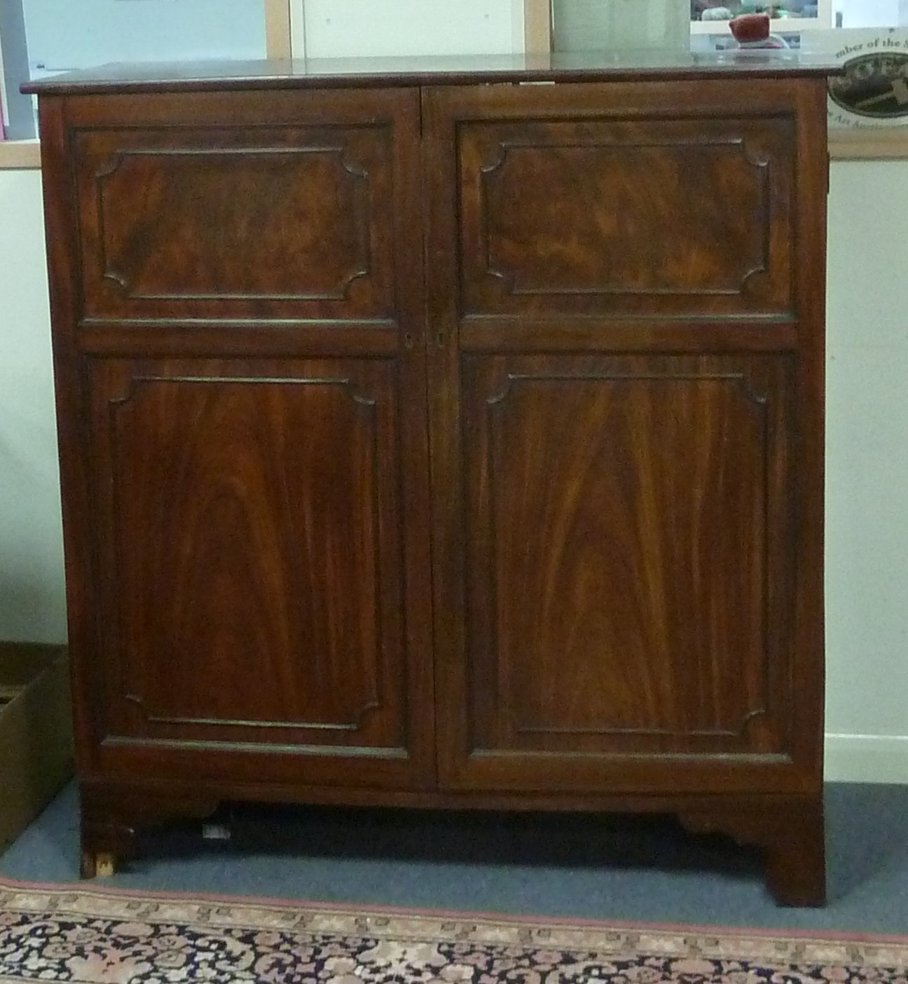 Appraisal: A th Century mahogany press cupboard the two fielded panel