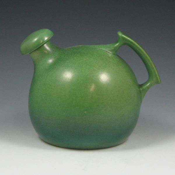 Appraisal: Rumrill matte green ball jug with stopper Marked Rumrill Mint