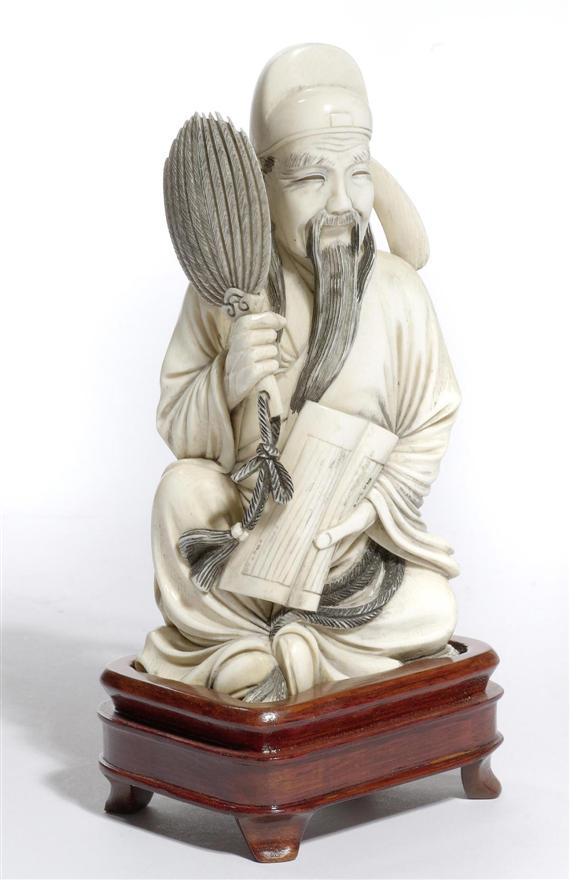 Appraisal: AN IVORY FIGURE OF A SITTING WISE MAN China circa