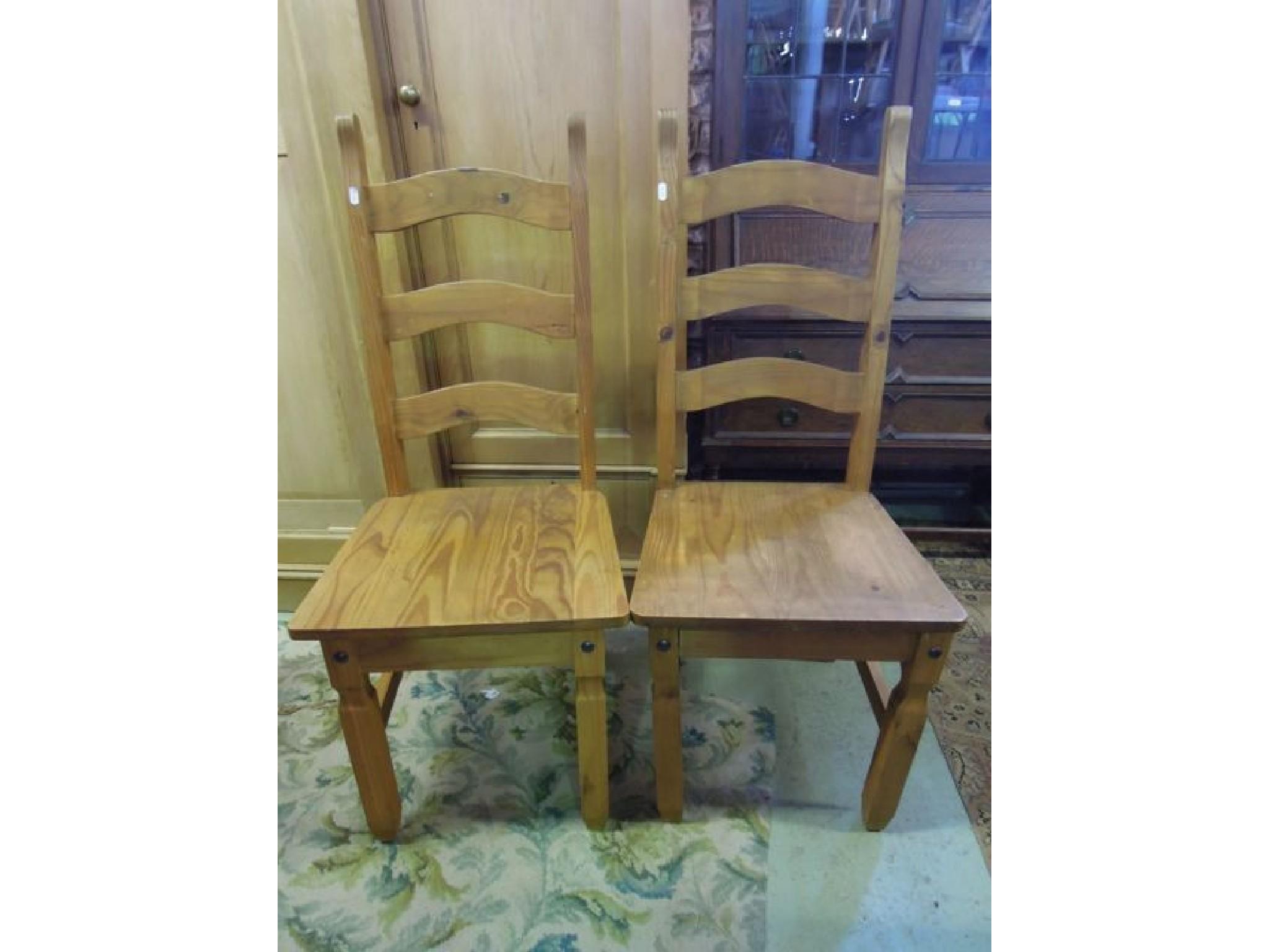 Appraisal: A set of six contemporary pine ladderback dining chairs with