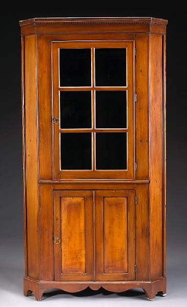 Appraisal: An American cherry and maple corner cupboard th century height