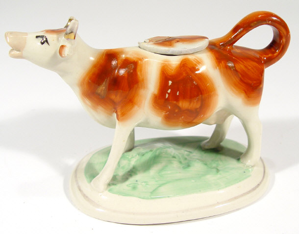 Appraisal: Staffordshire china cow creamer and lid with brown painted decoration