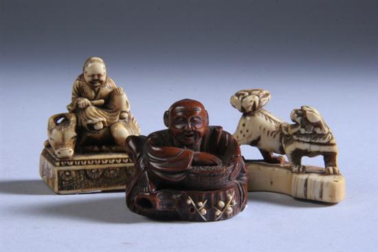 Appraisal: THREE JAPANESE IVORY NETSUKE th century Carved to depict a