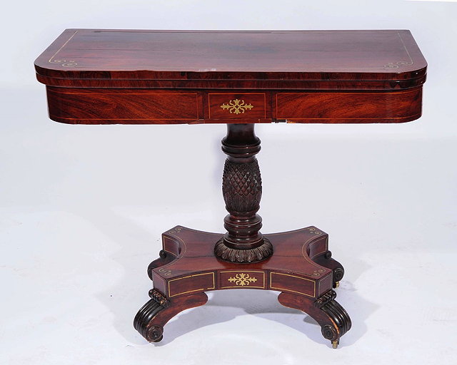 Appraisal: A REGENCY ROSEWOOD AND BRASS INLAID CARD TABLE with pineapple