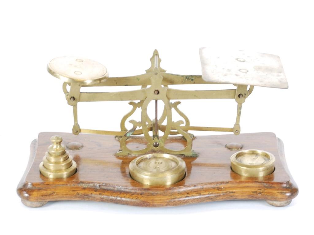 Appraisal: SET OF BRASS POSTAL SCALES on shaped oblong base with