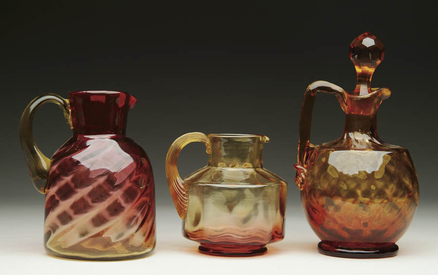 Appraisal: THREE AMBERINA PITCHERS Squat Amberina pitcher has inverted thumbprint pattern