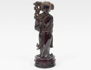 Appraisal: AMBER FIGURE OF GUANYIN Chinese Holding a chrysanthemum branch Height