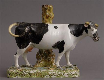 Appraisal: STAFFORDSHIRE LARGE COW-FORM VASE The spotted bovine standing against a