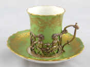 Appraisal: A ceramic tea cup and saucer the cup with silver