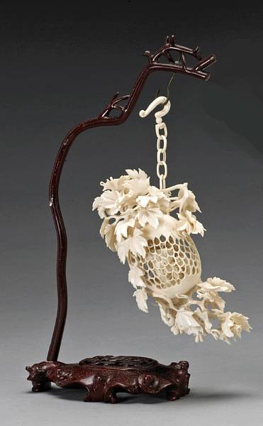 Appraisal: A small reticulated ivory hanging fruit th Century Its reticulated