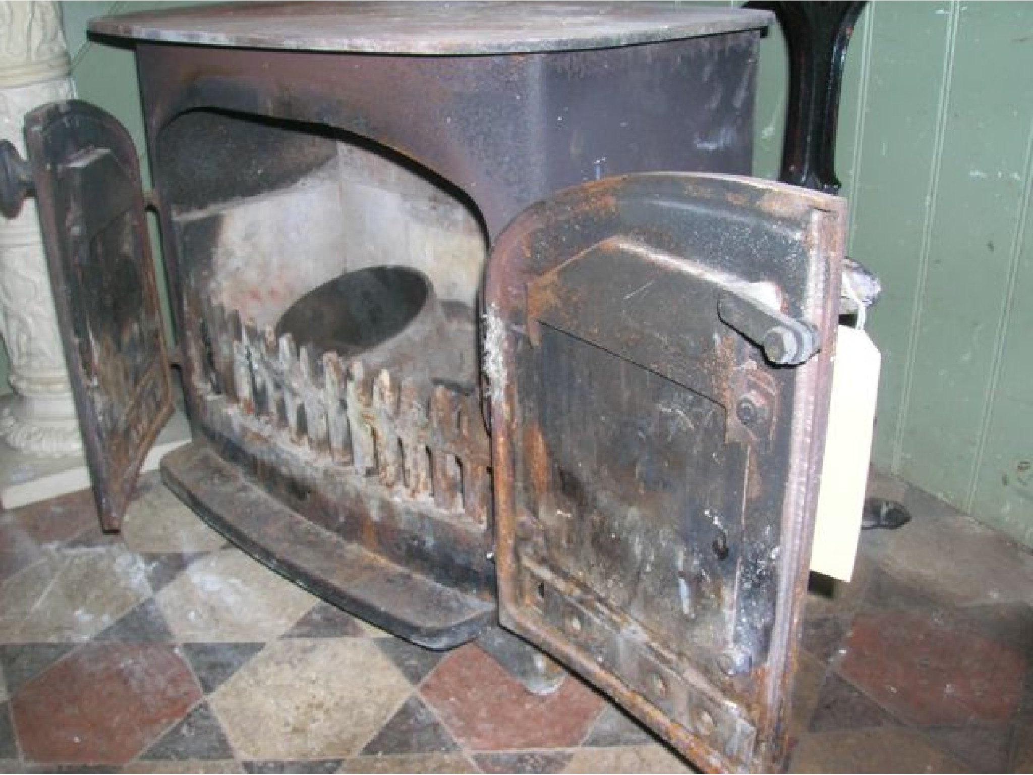 Appraisal: A Villager cast iron wood burner enclosed by a pair