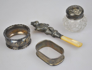 Appraisal: A silver baby rattle modelled as a two-faced teddy bear