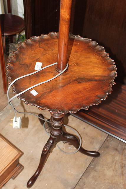 Appraisal: A WALNUT STANDARD LAMP OCCASIONAL TABLE with a turned column