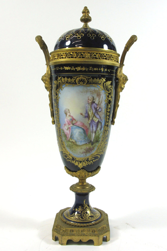 Appraisal: SEVRES PORCELAIN COVERED URN The cobalt blue field having opposing