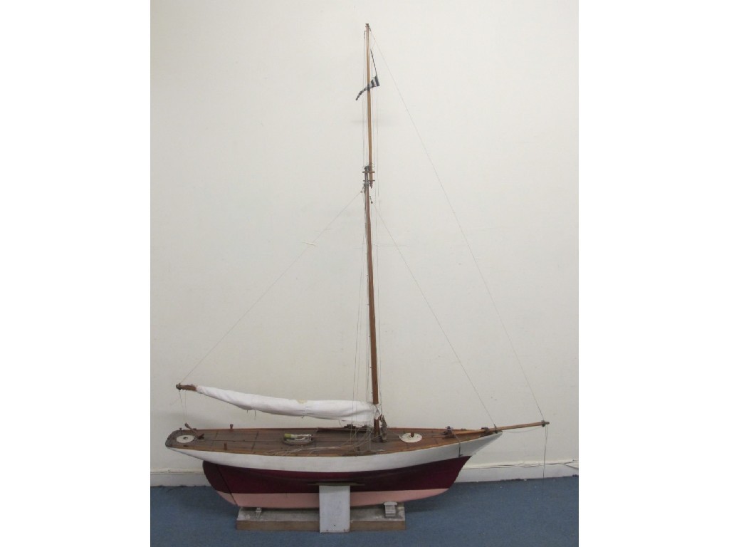 Appraisal: A large pond yacht with single mast rolled canvas sail