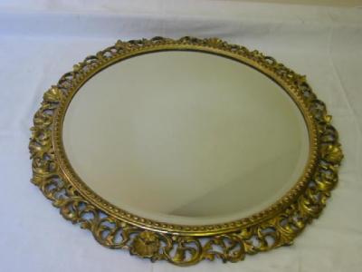 Appraisal: A WALL MIRROR of circular form the bevelled plate in