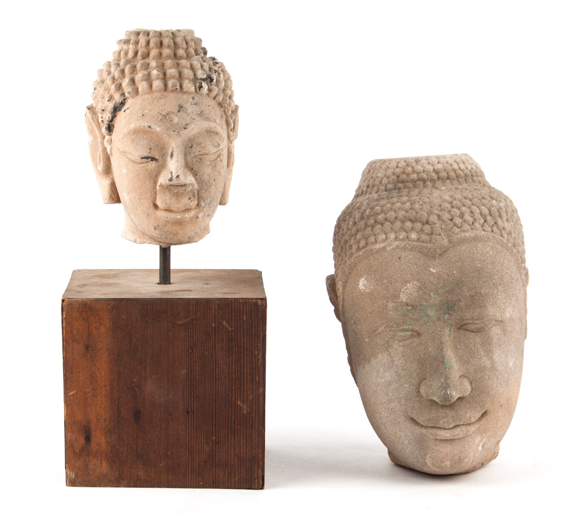 Appraisal: Two Thai carved stone heads of the Buddha one in