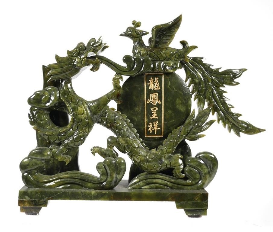 Appraisal: Chinese green hardstone carving of a dragon and phoenix Sculpture