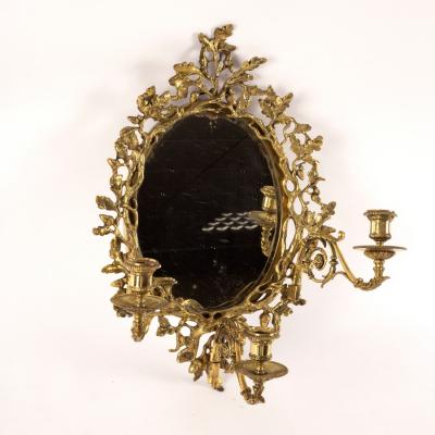 Appraisal: An oval wall mirror the gilt brass frame with surround