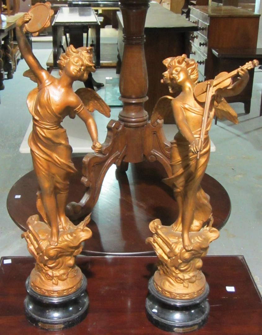 Appraisal: A pair of patinated spelter figures of dancing winged musicians