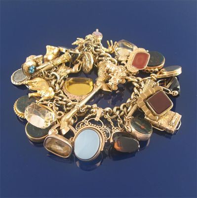 Appraisal: A substantial charm bracelet the gold curb link bracelet mounted