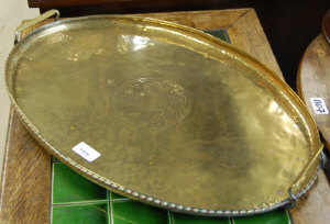 Appraisal: An Arts Crafts oval brass tray with engraved holly design