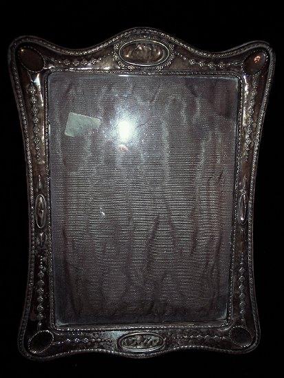 Appraisal: An embossed silver photograph frame Birmingham to take a photograph