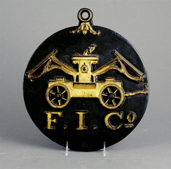 Appraisal: Painted cast-iron fire mark round backplate with raised gold painted