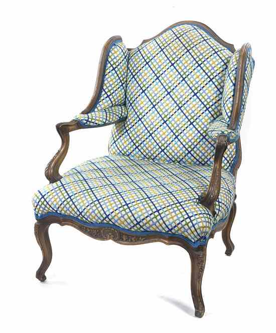 Appraisal: A French Provincial Style Wingback Fauteuil having an upholstered back