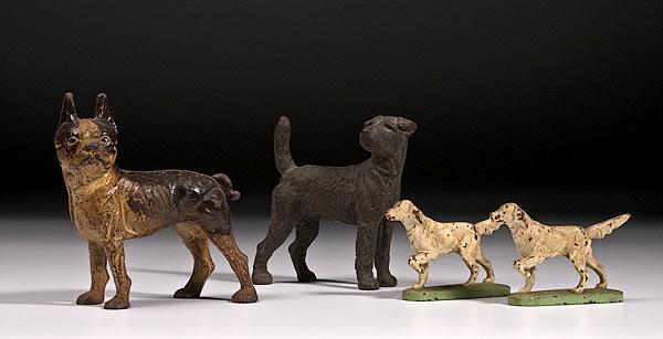 Appraisal: FOUR CAST IRON DOG DOOR STOPS American ca s Includes